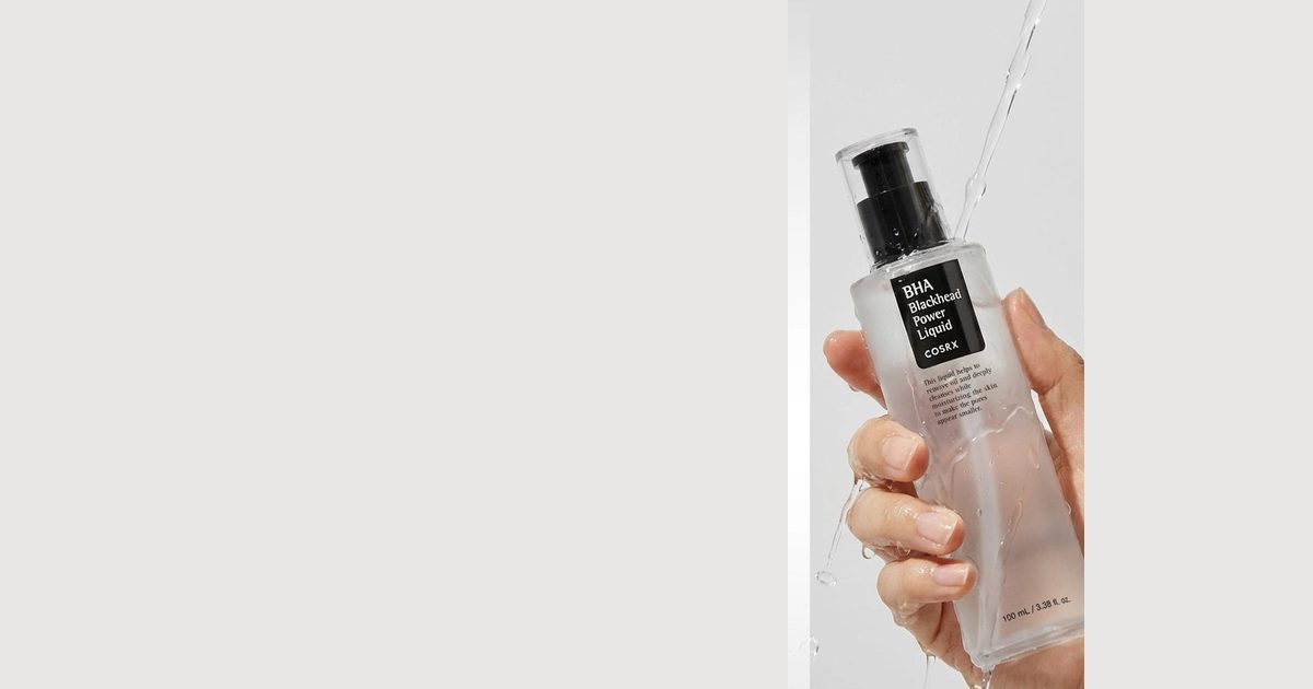 Close view of the clear COSRX BHA Blackhead Power Liquid bottle with its black pump and dark label